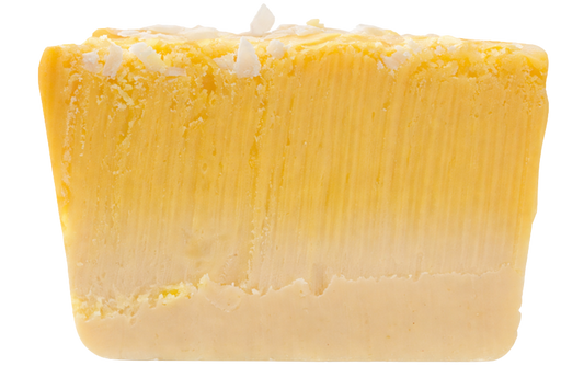 slice of two-tone pina colada fudge with coconut topping
