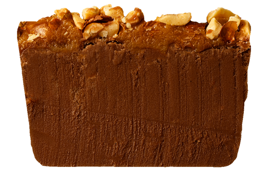 Slice of chocolate fudge with caramel and nut topping