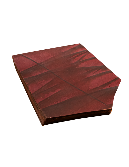 Piece of chocolate bark with red color brushed on top