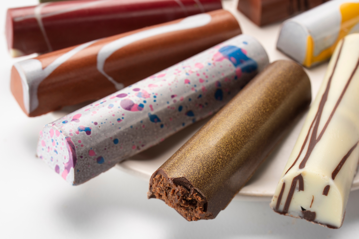 Close up of assorted colorful painted chocolate truffle bars