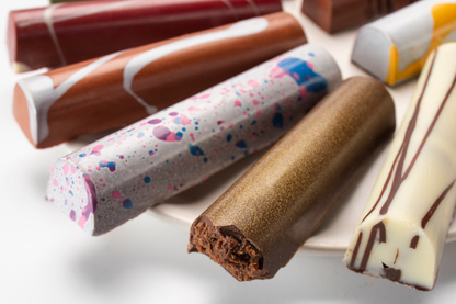 Close up of assorted colorful painted chocolate truffle bars