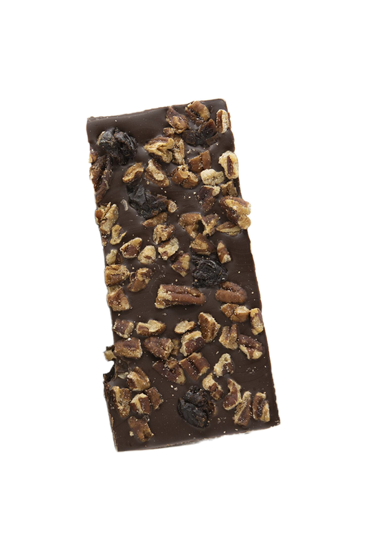 Slice of chocolate bark with pecans and cherries on a transparent background